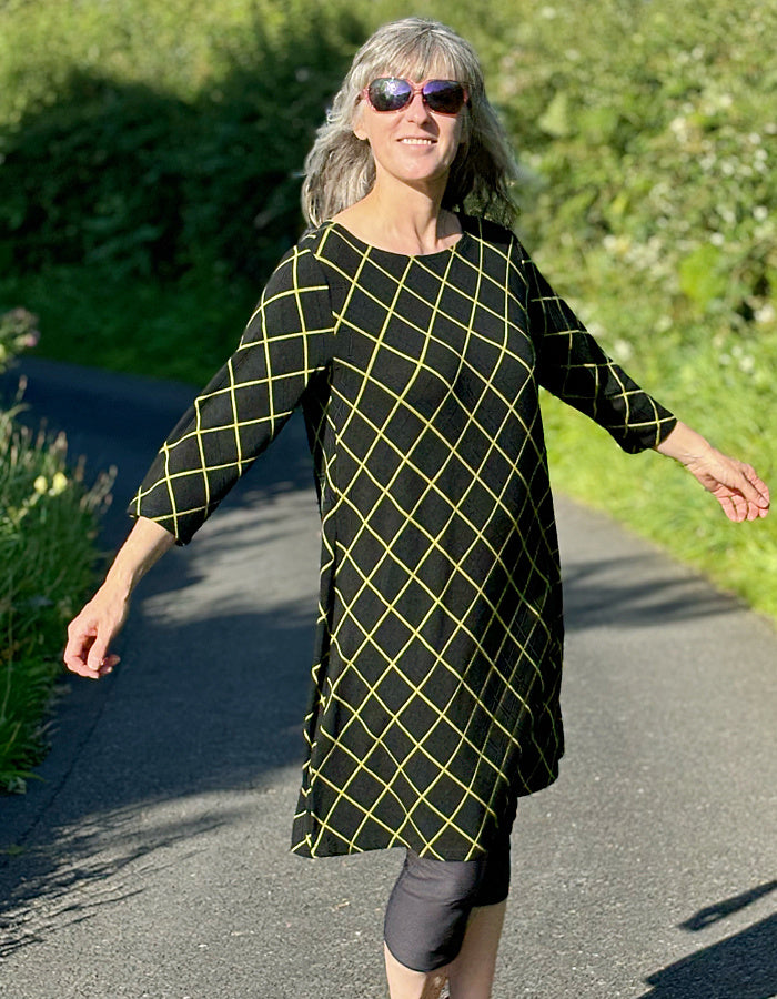 black shift dress with 3/4 length sleeve and lime green diamond design