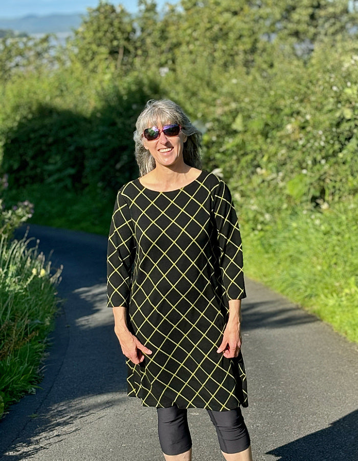 black shift dress with 3/4 length sleeve and lime green diamond design