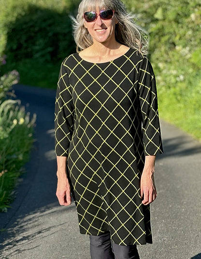 black shift dress with 3/4 length sleeve and lime green diamond design