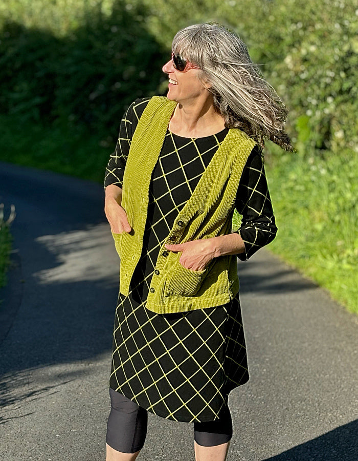 black shift dress with 3/4 length sleeve and lime green diamond design