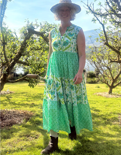 maxi length tiered sleeveless dress with a 70's retro vibe with a green and lime graphic floral print