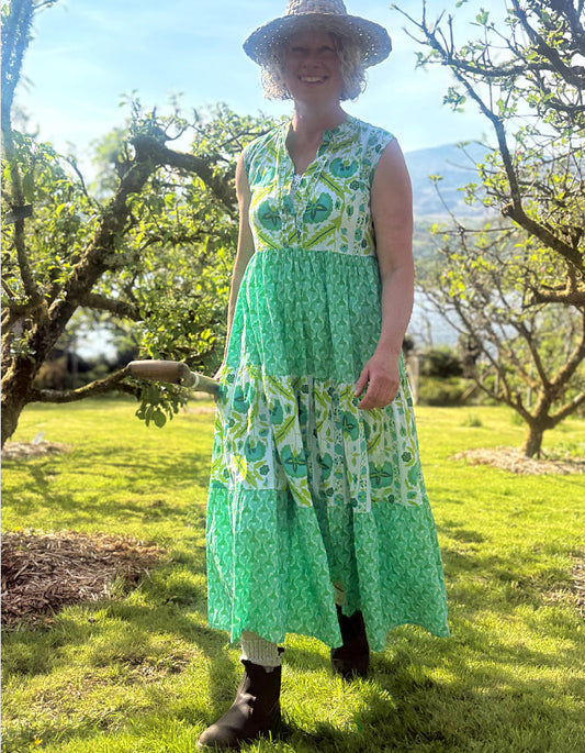 maxi length tiered sleeveless dress with a 70's retro vibe with a green and lime graphic floral print