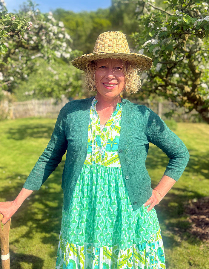 maxi length tiered sleeveless dress with a 70's retro vibe with a green and lime graphic floral print