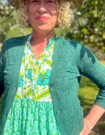 maxi length tiered sleeveless dress with a 70's retro vibe with a green and lime graphic floral print