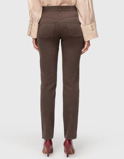 Rear view of a model wearing high-waisted brown straight-leg pants, paired with a light beige long-sleeve blouse and burgundy pointed-toe heels, against a light gray studio background.