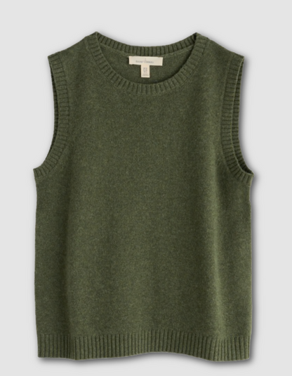 Woman wearing a green sleeveless merino sweater in olive green 