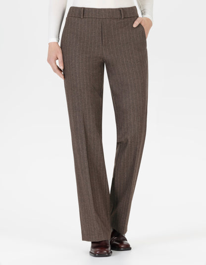 Brown pin stripe pants worn by a person on a white background