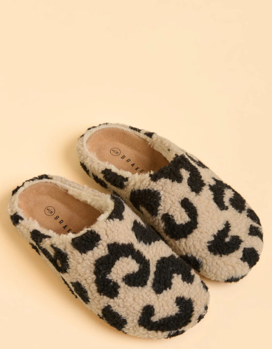 Pair of leopard print slippers on a beige background