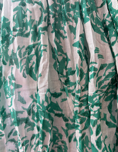Green leaf pattern on white fabric
