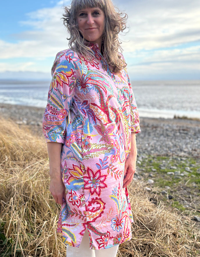 woman wearing a rose print cotton shirt dress over cream jeans