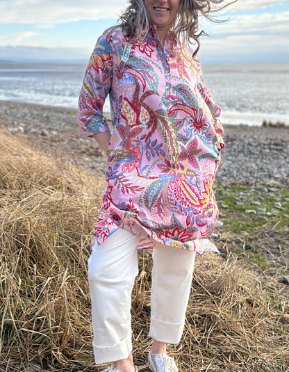 woman wearing a rose print cotton shirt dress over cream jeans