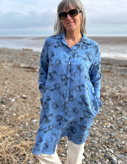woman wearing a blue floral linen shirt dress