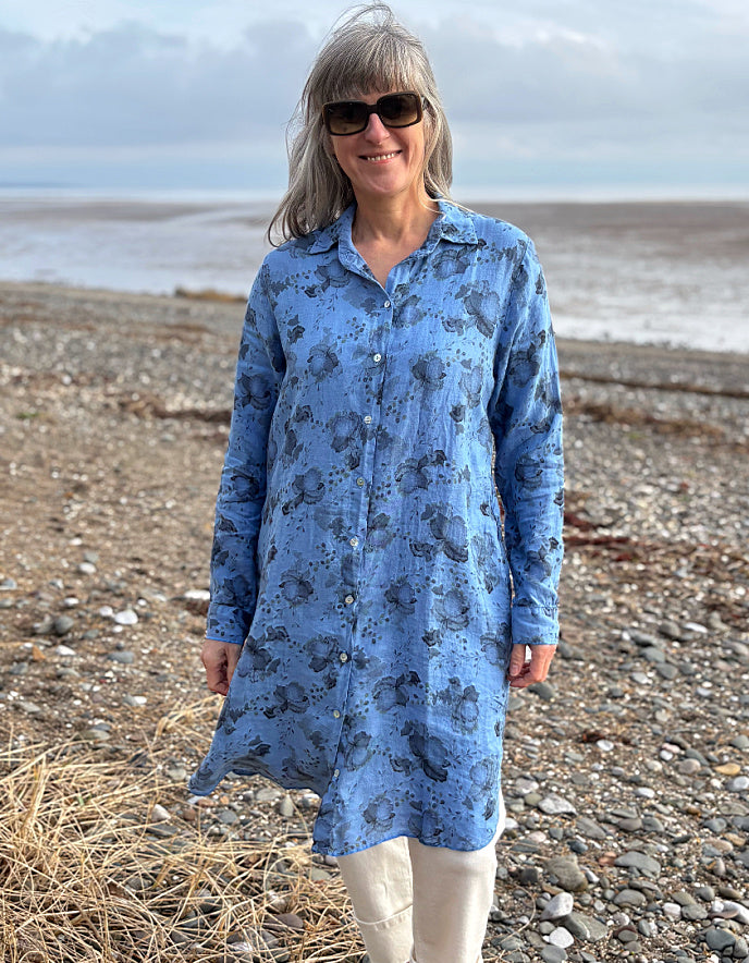 woman wearing a blue floral linen shirt dress