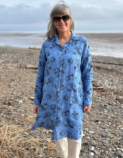 woman wearing a blue floral linen shirt dress