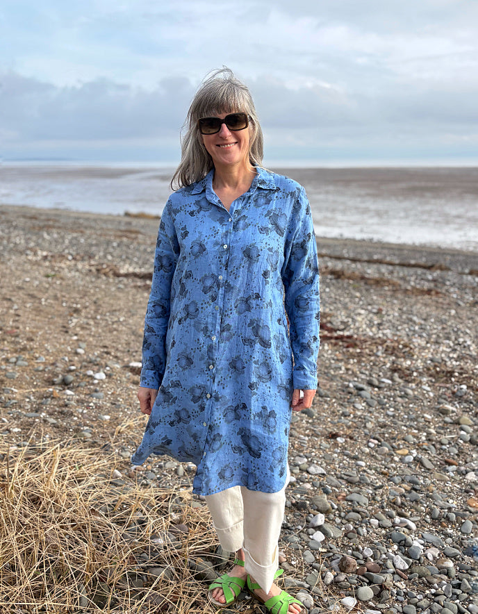 woman wearing a blue floral linen shirt dress