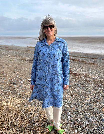 woman wearing a blue floral linen shirt dress