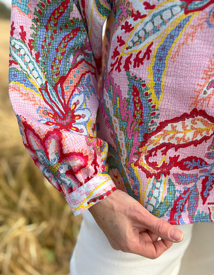 woman wearing a rose floral cotton blouse with white summer jeans