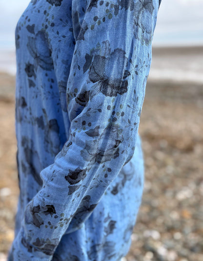 woman wearing a blue floral linen shirt dress