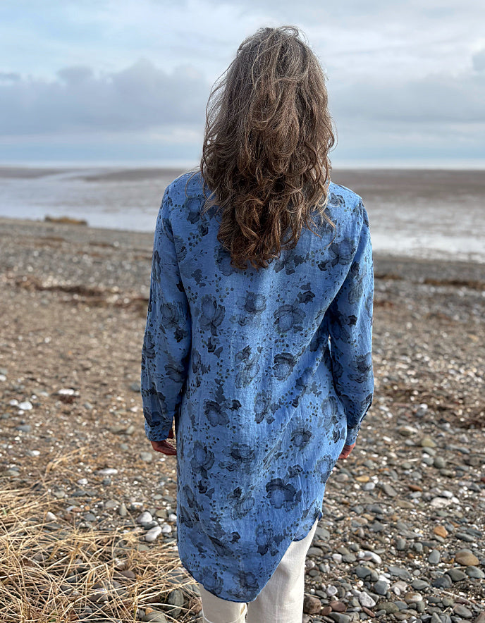 woman wearing a blue floral linen shirt dress