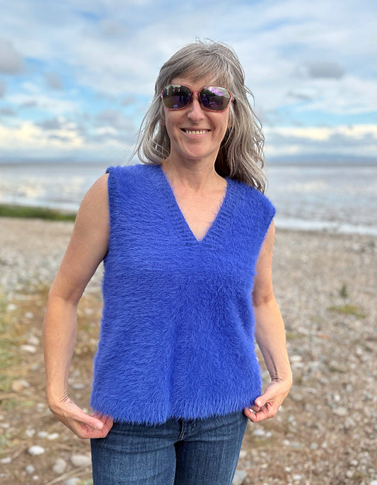 woman wearing cobalt blue fluffy V neck tank top and jeans