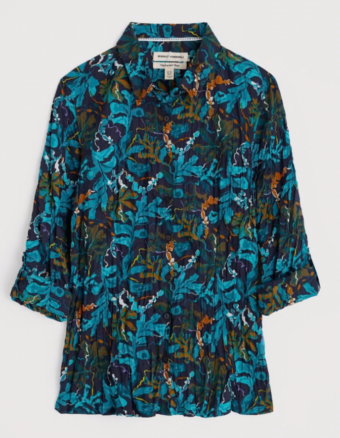 Floral patterned shirt with a brand label on a white background