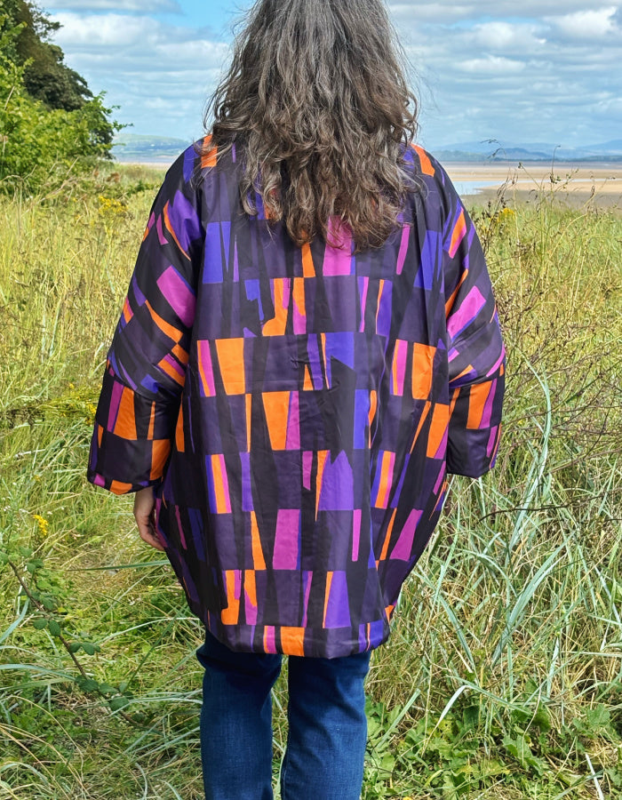 reversible oversized lightweight coat in black and purple and orange print