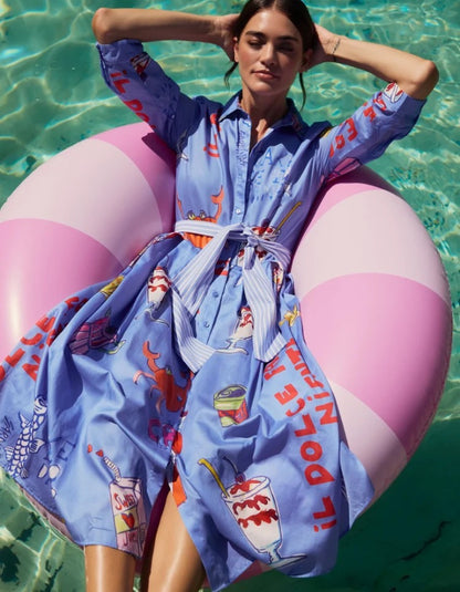 Woman in a colorful robe with a pink and white inflatable ring in a pool