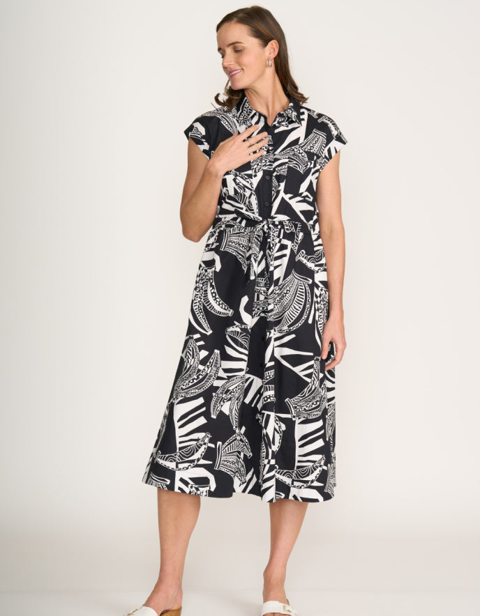 Woman wearing a black and white patterned dress on a white background