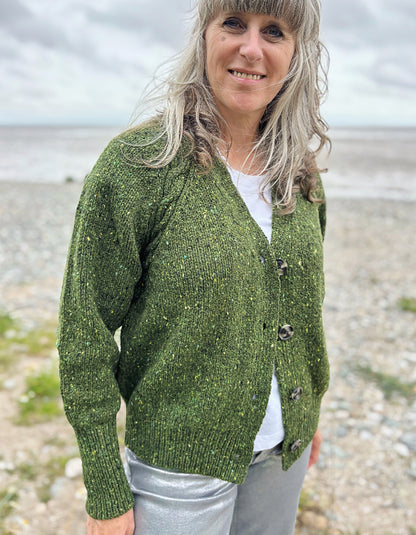 Person wearing a donegal tweed green knitted cardigan  in a natural 