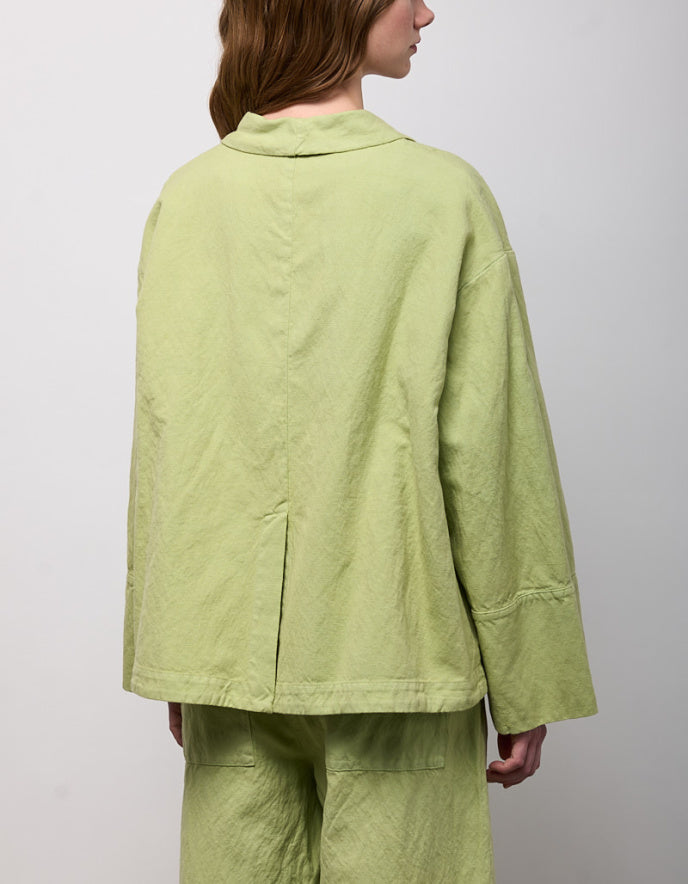 woman wearing pesto green linen jacket