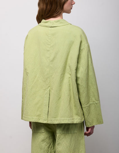 woman wearing pesto green linen jacket