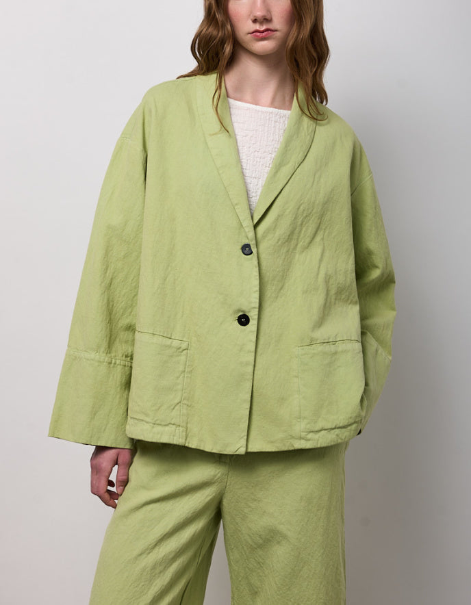 woman wearing pesto green linen jacket
