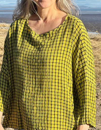 oversized one size top with drape. ochre shade of green with black check print, round neckline