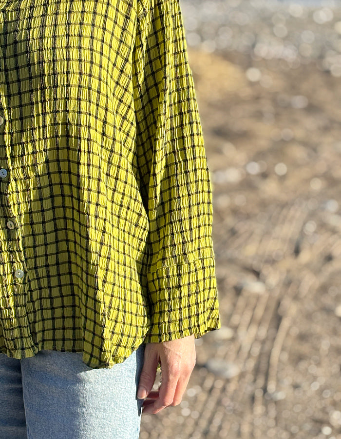 ochre green viscose swing shirt with black check print. box pleat at the back