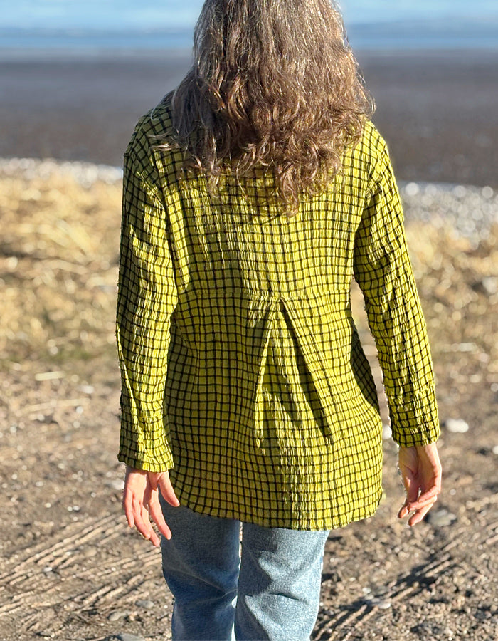 ochre green viscose swing shirt with black check print. box pleat at the back