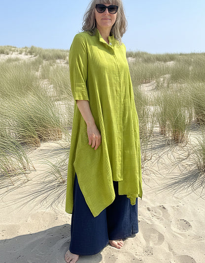 woman wearing lime cotton coat dress on a beach
