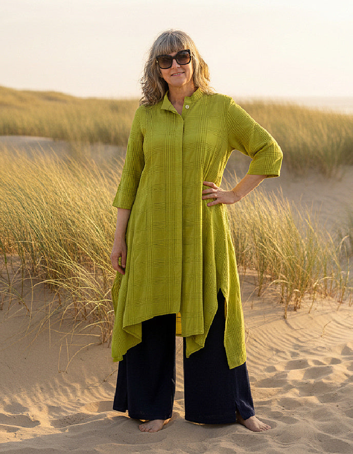 woman wearing lime cotton coat dress on a beach