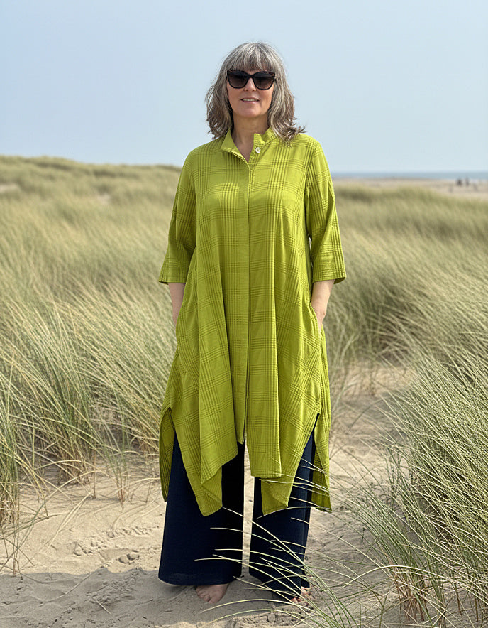woman wearing lime cotton coat dress on a beach