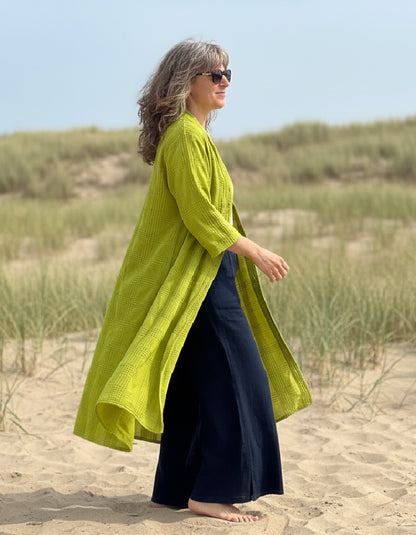 woman wearing lime cotton coat dress on a beach