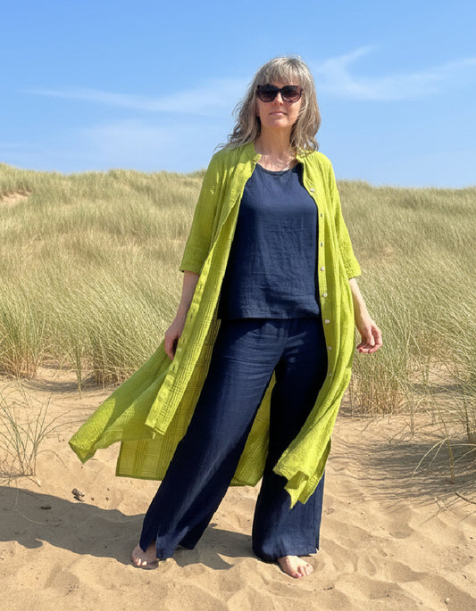 woman wearing lime cotton coat dress on a beach