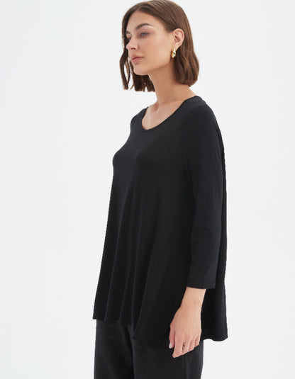 Woman wearing a black sweater on a white background