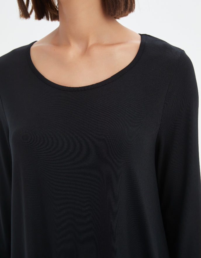Black long-sleeve top with a subtle pattern on a white background