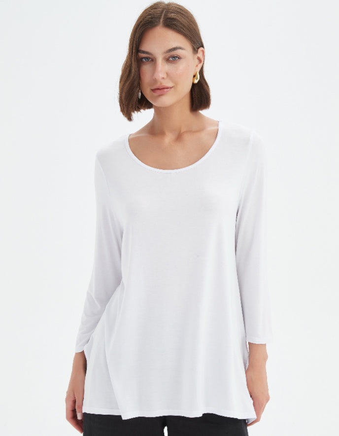 Woman wearing a white blouse against a plain background