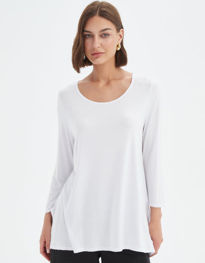 Woman wearing a white blouse against a plain background