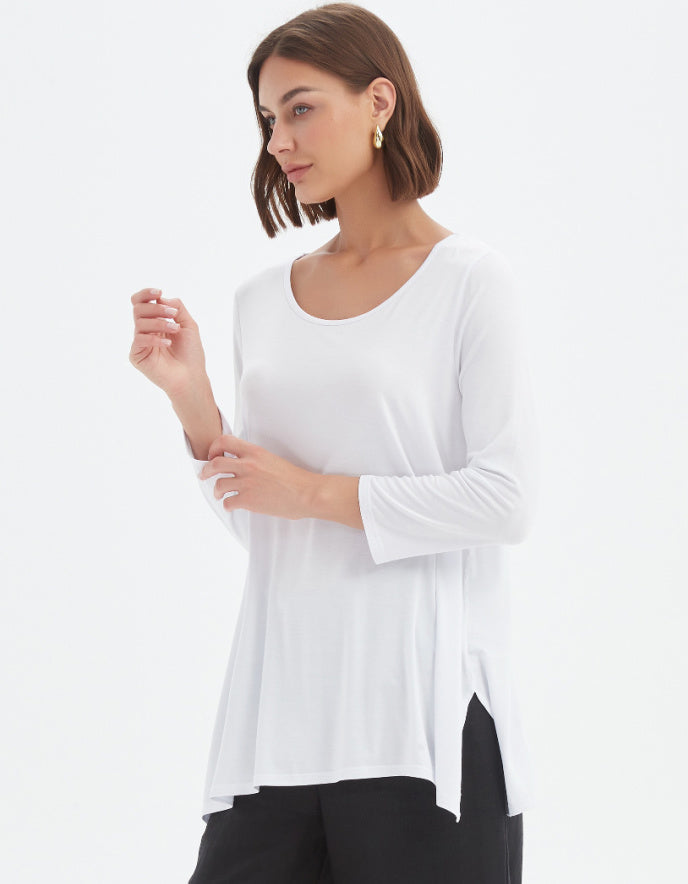Woman wearing a white long-sleeve top on a white background