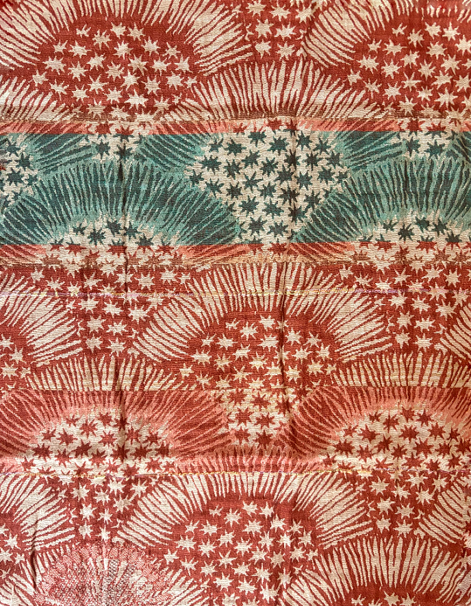 Patterned jacquard organic cotton scarf with star designs in terracotta, green and cream
