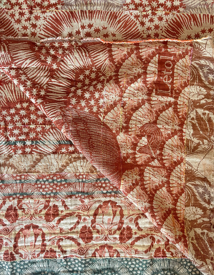 Patterned jacquard organic cotton scarf with star designs in terracotta, green and cream