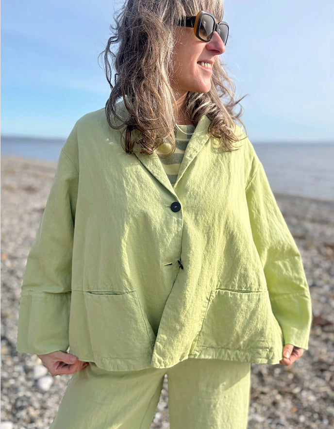 Person wearing a light green outfit on a beach