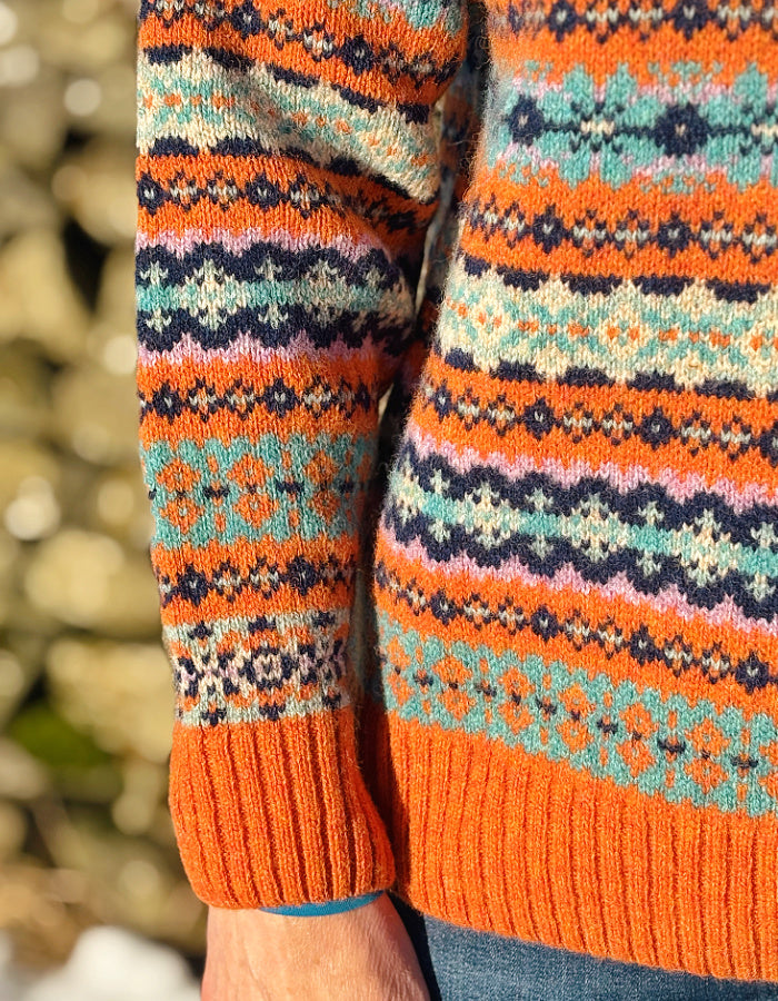 orange and teal all over Fair Isle sweater with orange ribbed hem cuffs and neckline. made from lambswool supersoft