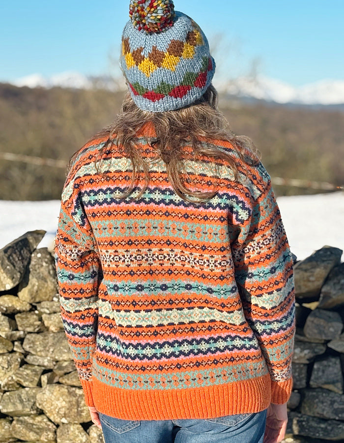 orange and teal all over Fair Isle sweater with orange ribbed hem cuffs and neckline. made from lambswool supersoft